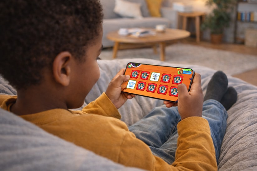 Boy using the smart minis app to learn words.